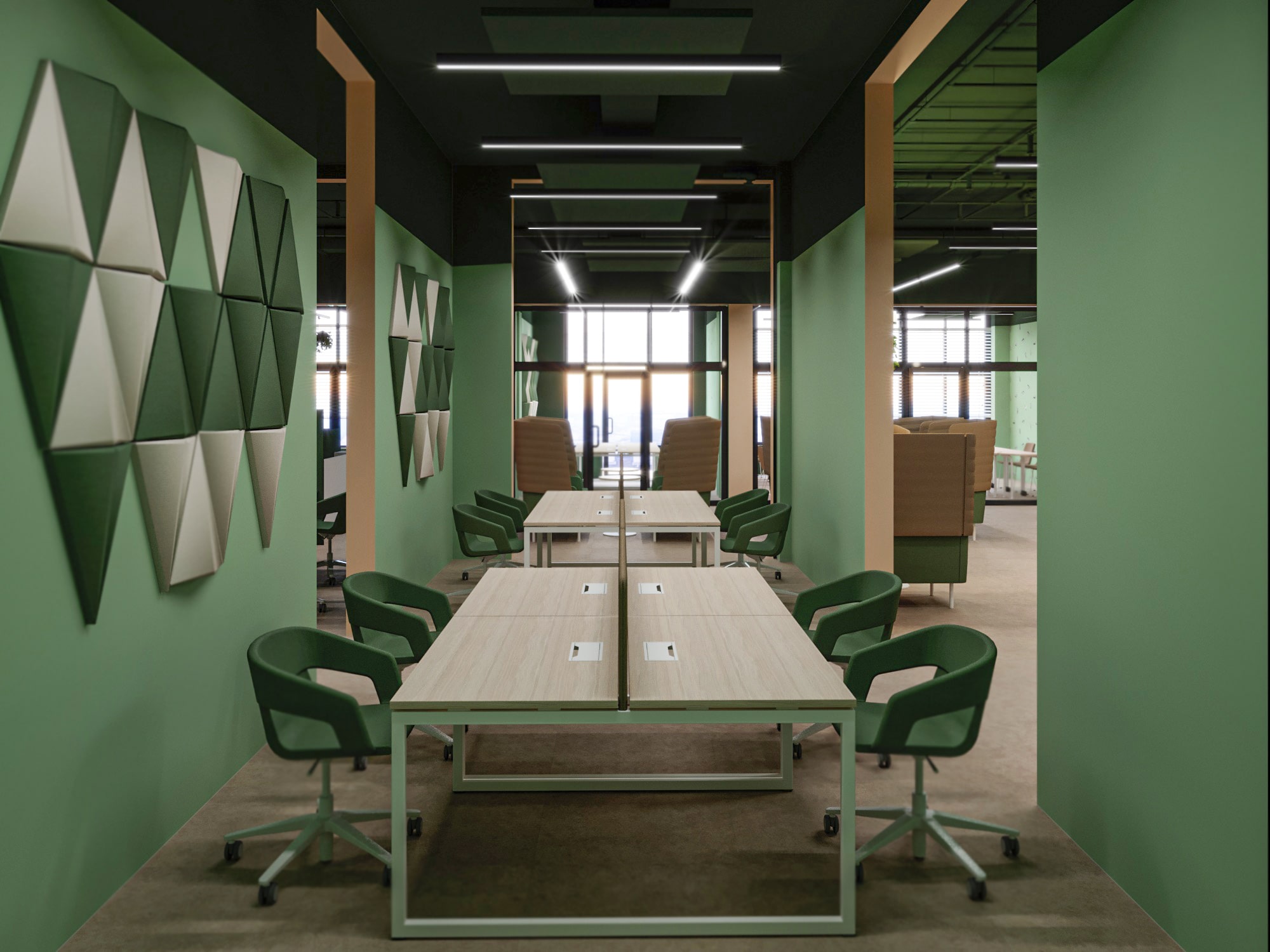 Modern coworking space at Mont Eco featuring a green and beige color scheme. The area is equipped with large desks and green chairs. The walls are decorated with geometric panels, and the space is well-lit with natural light from large windows.
