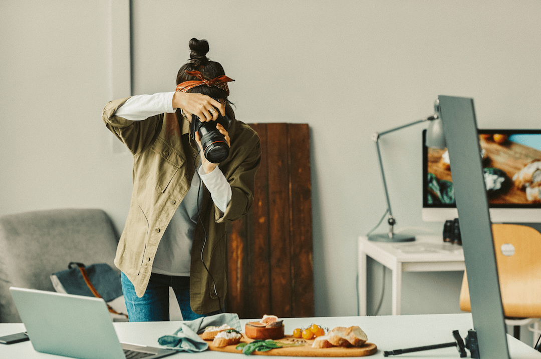 a woman taking a picture of food