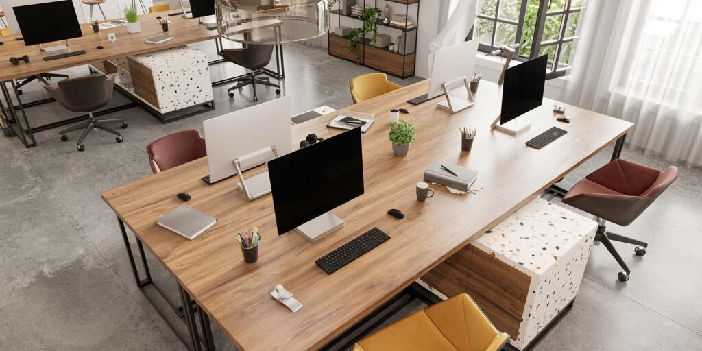 a desk with computers and other office supplies