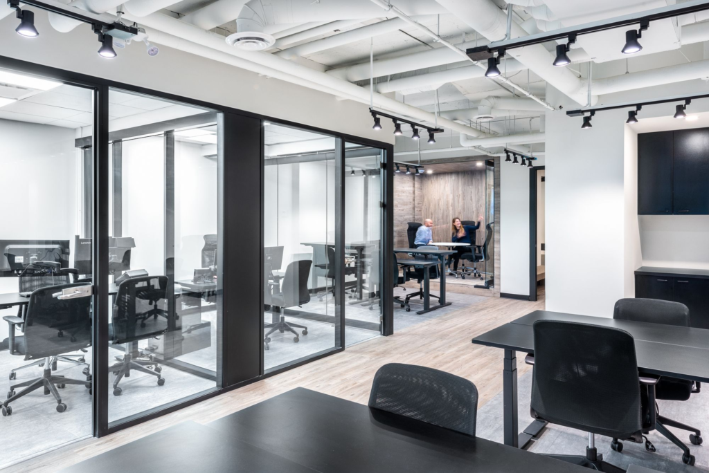 a room with glass walls and tables and chairs