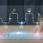 Person typing with digital icons displayed