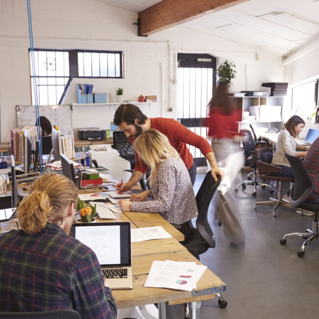 busy office with people collaborating