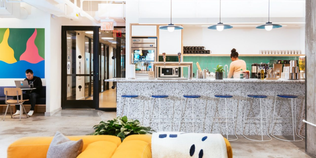 Nine benefits of coworking spaces a woman sitting at a counter in a room