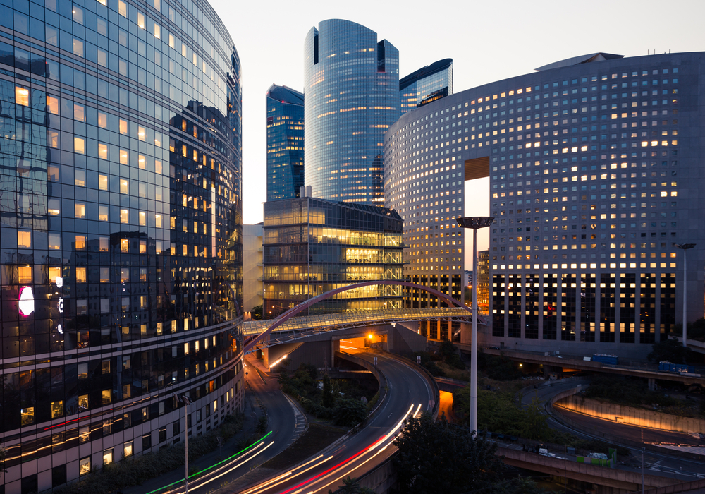 How to find commercial office space for rent Modern cityscape with illuminated buildings.
