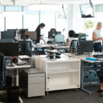 Busy office with multiple employees working.