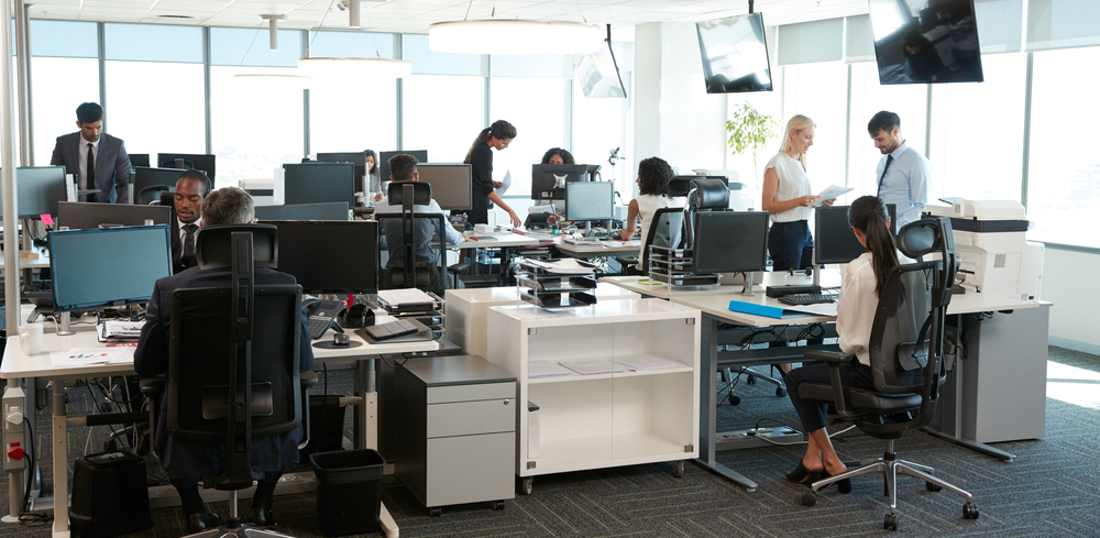 Busy office with multiple employees working.