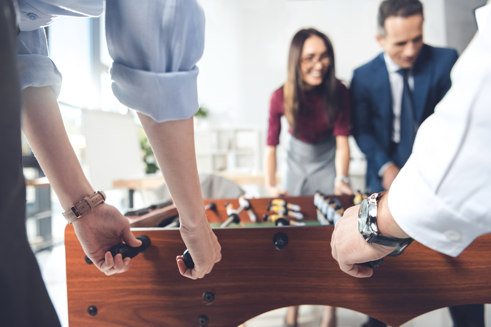 People playing foosball in office