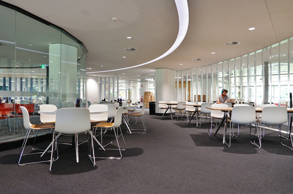 What is a collaboration hub? Modern, spacious office with empty tables.