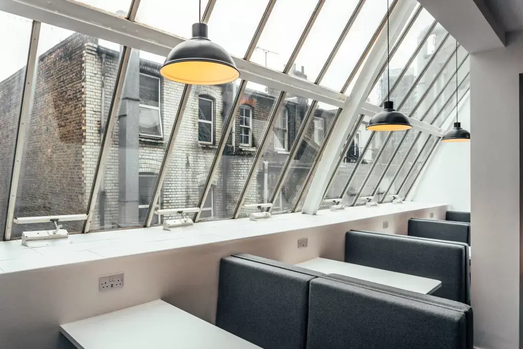 a room with a window and a row of tables