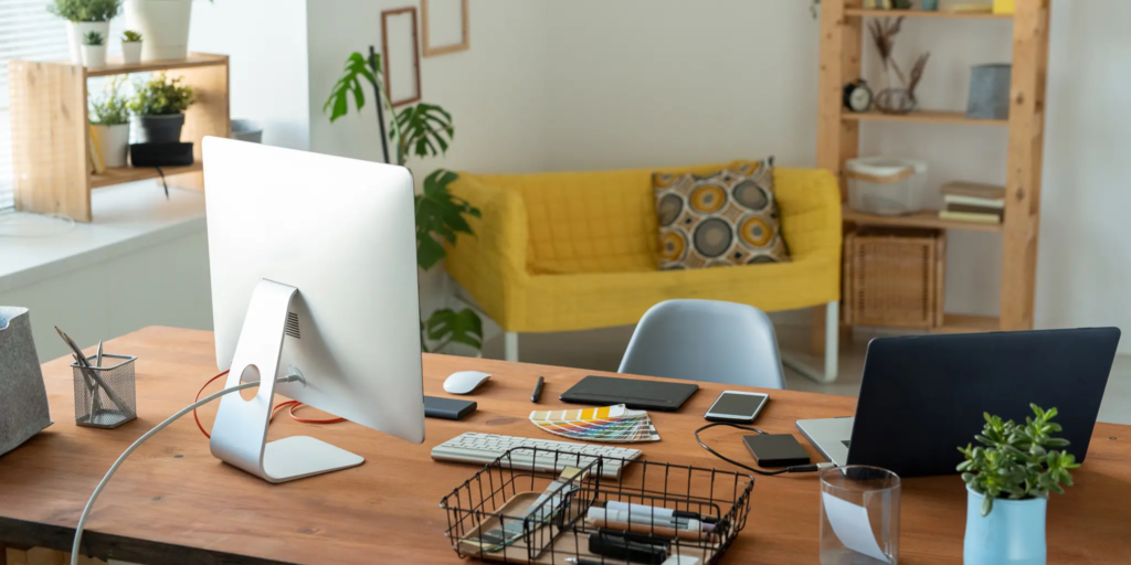 a desk with a computer and other objects on it