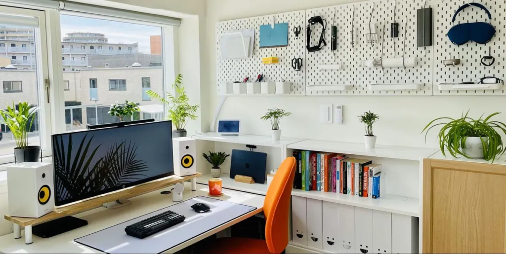 a desk with a computer and books on it