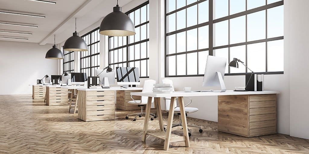 a large office with white desks and white chairs