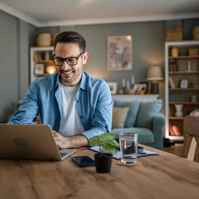 Person working on laptop at home.