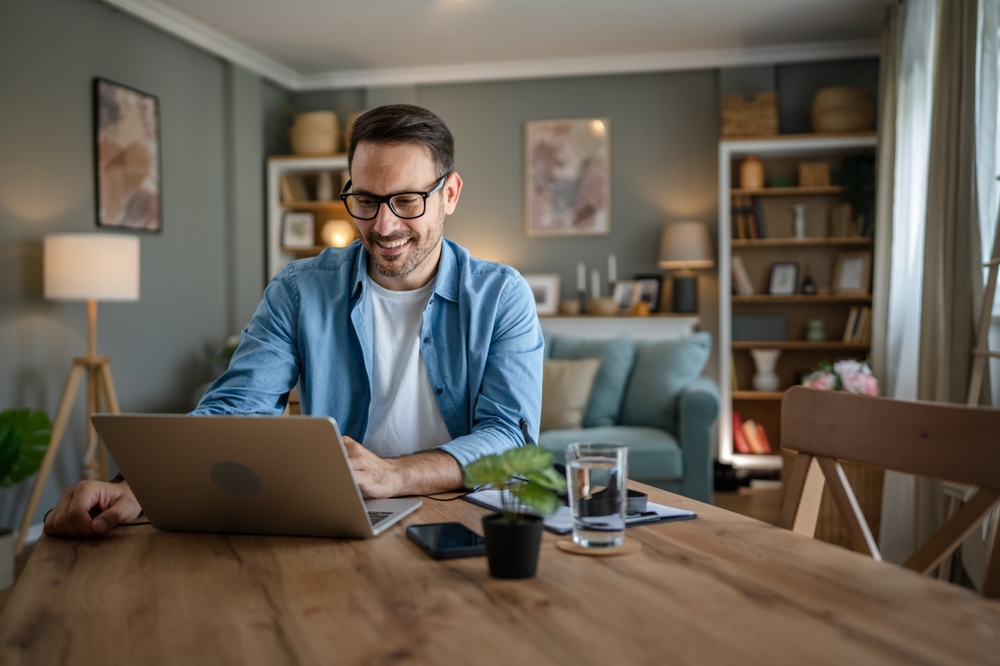 Person working on laptop at home.