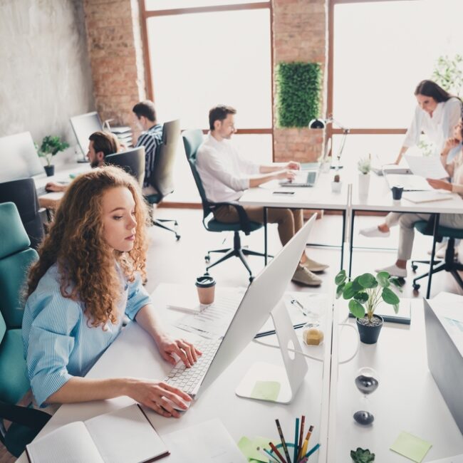 Modern office with people working collaboratively.