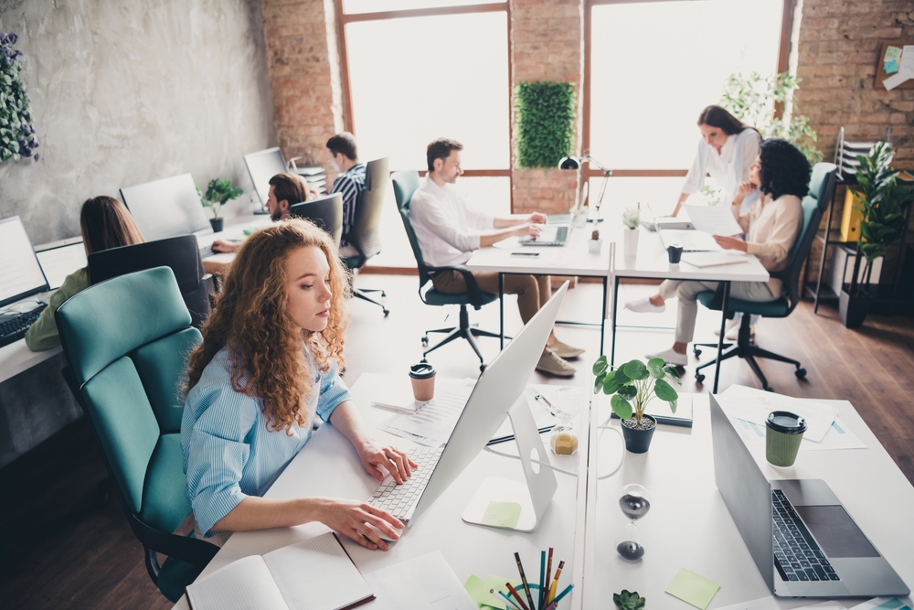 Modern office with people working collaboratively.