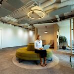 Modern office space with green seating.