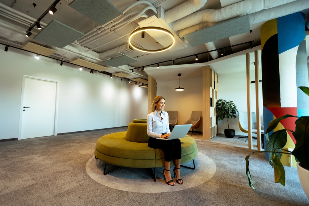Modern office space with green seating.